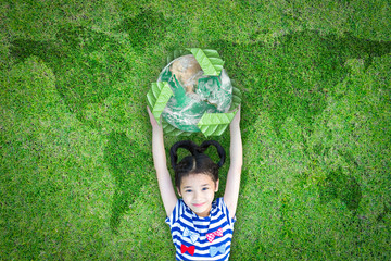 Sustainable world environment and CSR with people campaign concept with girl kid raising earth on green lawn: Element of the image furnished by NASA