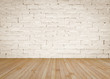 © Chinnapong - Brick wall painted in cream beige color with wooden floor textured background in natural yellow brown
