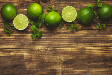 Fresh limes on wooden background