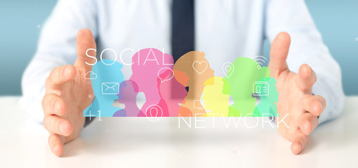 Poster - Businessman holding a colorfull social network teamwork with icon 3d rendering