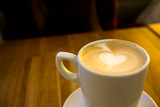 Fototapeta Mapy - Cappuccino coffee with heart shaped crema in a white cup