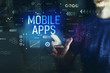 © Tierney - Mobile apps with young man touching screen at night
