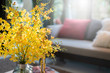 beautiful yellow flower vase with sofe living room home interior background
