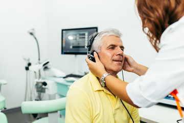 Senior man at medical examination or checkup in otolaryngologist's office