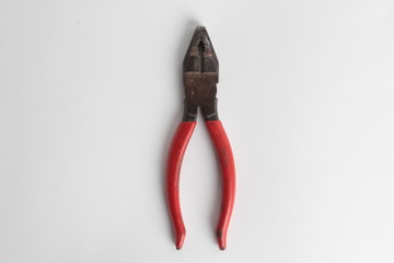 old red pliers in white background