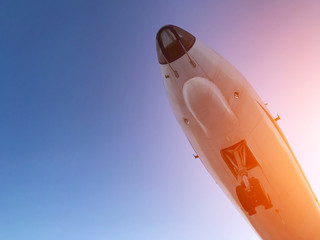 Close-up of airplane departure over background of sky and sun