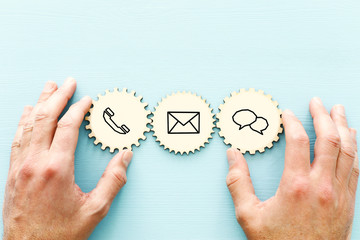 wooden cogwheel with contact us icons