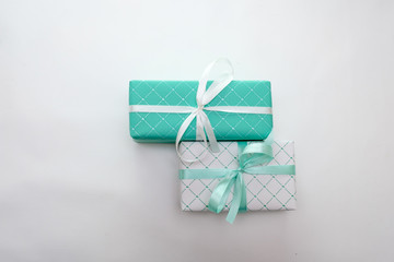 Green and white gift boxes with ribbons isolated on white background, holidays