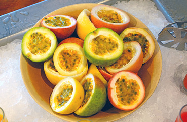 Wall Mural - A plate of juicy passion fruit cut in half