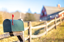 Mail Box With Raised Mailbox Flag Outside. American Mailbox. Rural View, Blurred Background