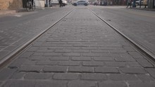 Walk Over Trolley Tracks Slow Motion. Slow Motion Low Angle View Moving Over Trolley Track Rails On A City Street