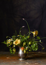 Flower Arrangement With Pansies, Strawberries And Herbs With Dark Background