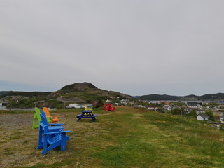 Colourful chairs on a mountain