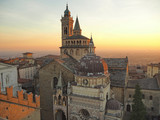 Fototapeta  - Bergamo, Italy. The old town. Aerial view of the Basilica of Santa Maria Maggiore and the chapel Colleoni during the sunset