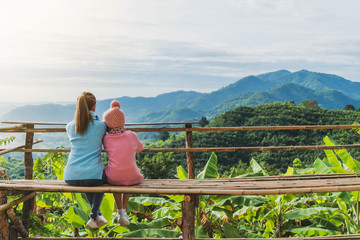 Mother and daughter looked at the mountain.