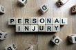 Personal injury text from wooden blocks on desk