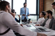© alfa27 - Businessman in blue formal suit standing and leading business meeting. Male chief executive putting his ideas during presentation in boardroom.
