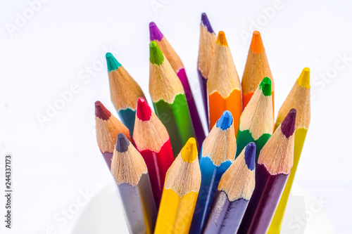Fotografía Colored pencils arranged in a group on white background