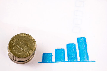 Stack of coins with blue charts on white background.