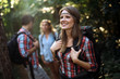 Young ans happy people trekking in forest