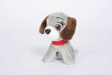 Soft toy dog with brown ears on a white background