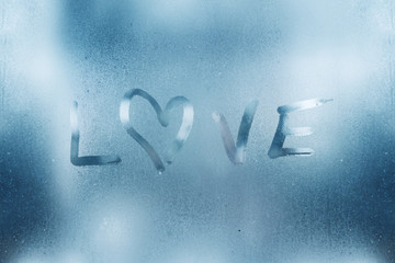 Wall Mural - The heart is painted on the misted glass in the winter.