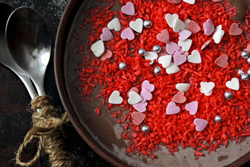 Chocolate pudding in a bowl decorated with Valentine's day hearts and decorations. Romantic breakfast for lovers.