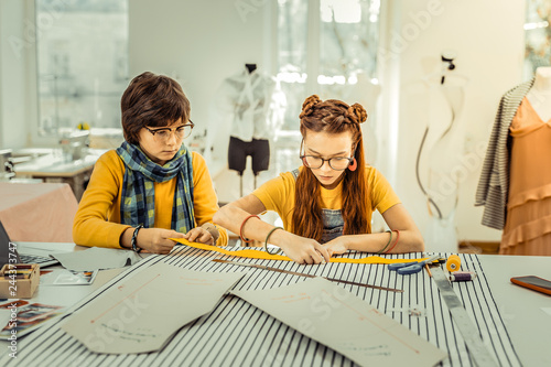 Fotografía Children helping their mother who is designer to draft patterns