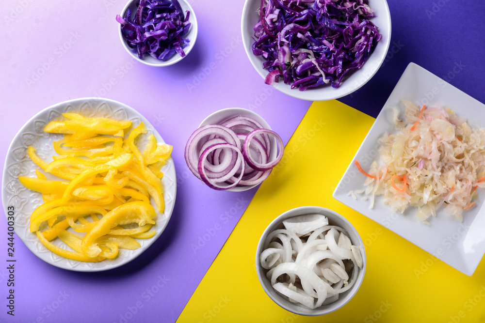 Assortment of tasty fermented vegetables on color background