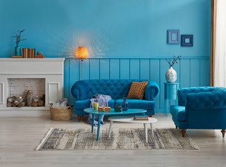 Decorative living room, modern blue wall, blue furniture sofa and orange lamp.