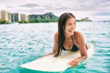 Surf Class In Waikiki Hawaii - Surfing Asian Surfer Girl On Surfbaord Lesson In Hawaii Paddling In Ocean Waves. Sexy Sports Athlete Training In Water. Watersport Active Lifestyle.