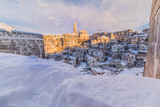 Fototapeta Do pokoju - panoramic view of typical stones Sassi di Matera and church of Matera 2019 under blue sky with clouds and snow on the house, concept of travel and christmas holiday,capital of europe culture 2019