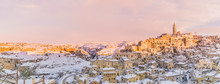 Panoramic View Of Typical Stones Sassi Di Matera And Church Of Matera 2019 Under Blue Sky With Clouds And Snow On The House, Concept Of Travel And Christmas Holiday,capital Of Europe Culture 2019