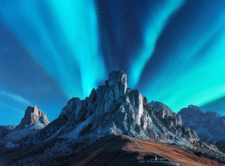 Wall Mural - northern lights above mountains at night in europe. aurora borealis. starry sky with polar lights an