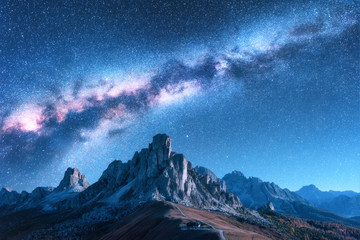 Wall Mural - milky way above mountains at night in autumn. landscape with alpine mountain valley, blue sky with m