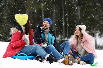 Sticker - People with plastic sleds outdoors. Winter vacation