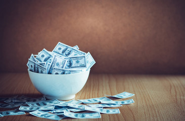 Dollar bill in white bowl with vintage color tone. concept investment, profit