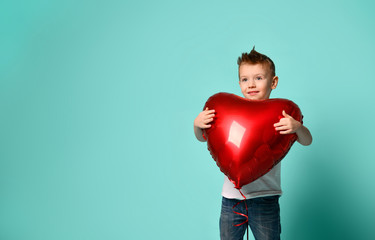 Little boy love hold big red heart balloon to celebrate valentines day on popular green 