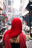 Fototapeta Uliczki - Woman wearing red headscarf walking along street, Varanasi, India