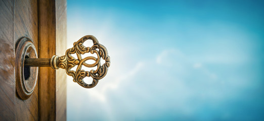 Fototapete - Old key in keyhole on sky background with sun ray . Concept, symbol and Idea for History, business, security, religion background.