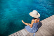 © GVS - Happy woman in hat relaxing on sea pier in Sardinia island, Italy