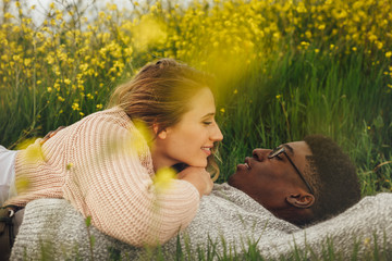 Wall Mural - romantic couple lying in meadow
