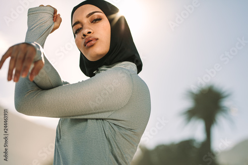 Fotomural Muslim female exercising outdoors in morning