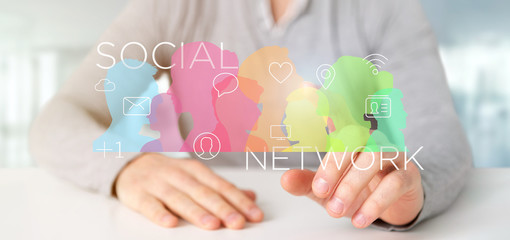 Poster - Businessman holding a colorfull social network teamwork with icon 3d rendering