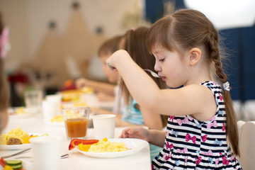 Wall Mural - children eating healthy food in daycare centre or kindergarten