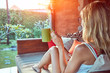© astrosystem - Girl enjoying morning coffee on the garden sofa.