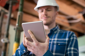 Architect Inside House Being Renovated Using Digital Tablet