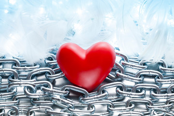Wall Mural - Red heart on metal chains and white feathers background
