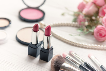 Valentine Gift. Makeup cosmetics tools background and beauty cosmetics, products and facial cosmetics package lipstick with pink rose, Pearl necklace, vintage tone.  Lifestyle and Valentine Concept