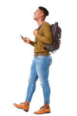 Full body side of happy young african american man walking on isolated white background with cellphone and bag